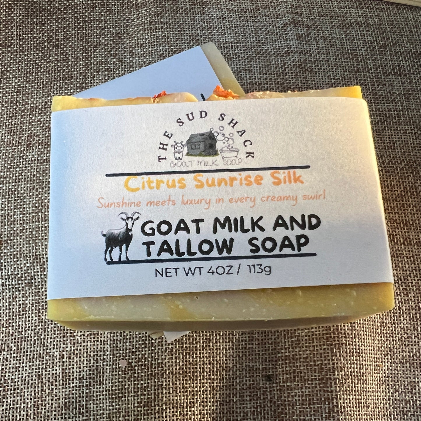 Bar of soap with a label on a textured surface