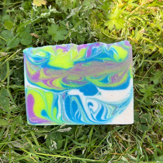 Colorful soap bar with a marbled pattern on grass