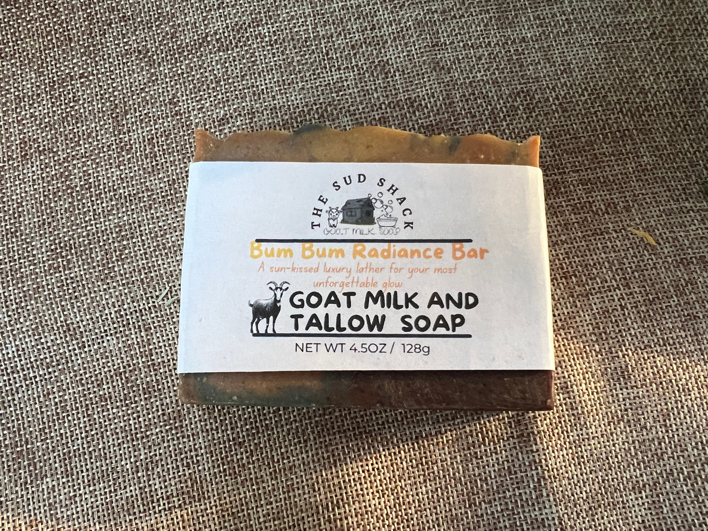 Bar of soap with a label on a textured fabric background