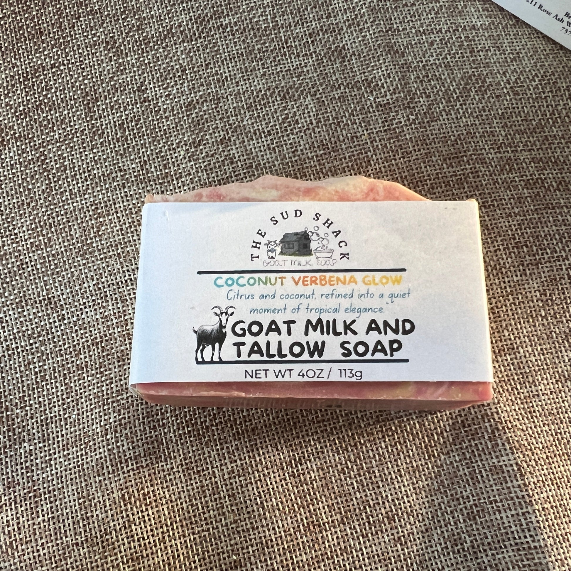 Bar of soap with a label on a textured surface