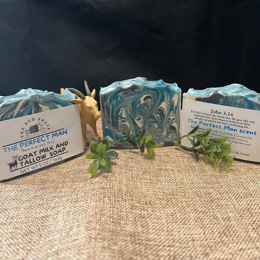 Three bars of soap with decorative labels on a textured surface