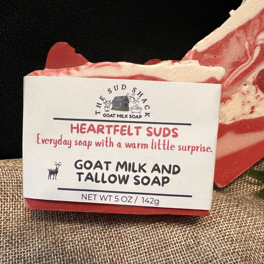 Bar of soap with packaging labeled 'Heartfelt Suds' on a textured surface.
