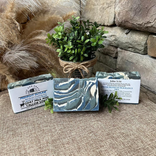 Three soap bars with packaging on a stone surface with decorative elements.