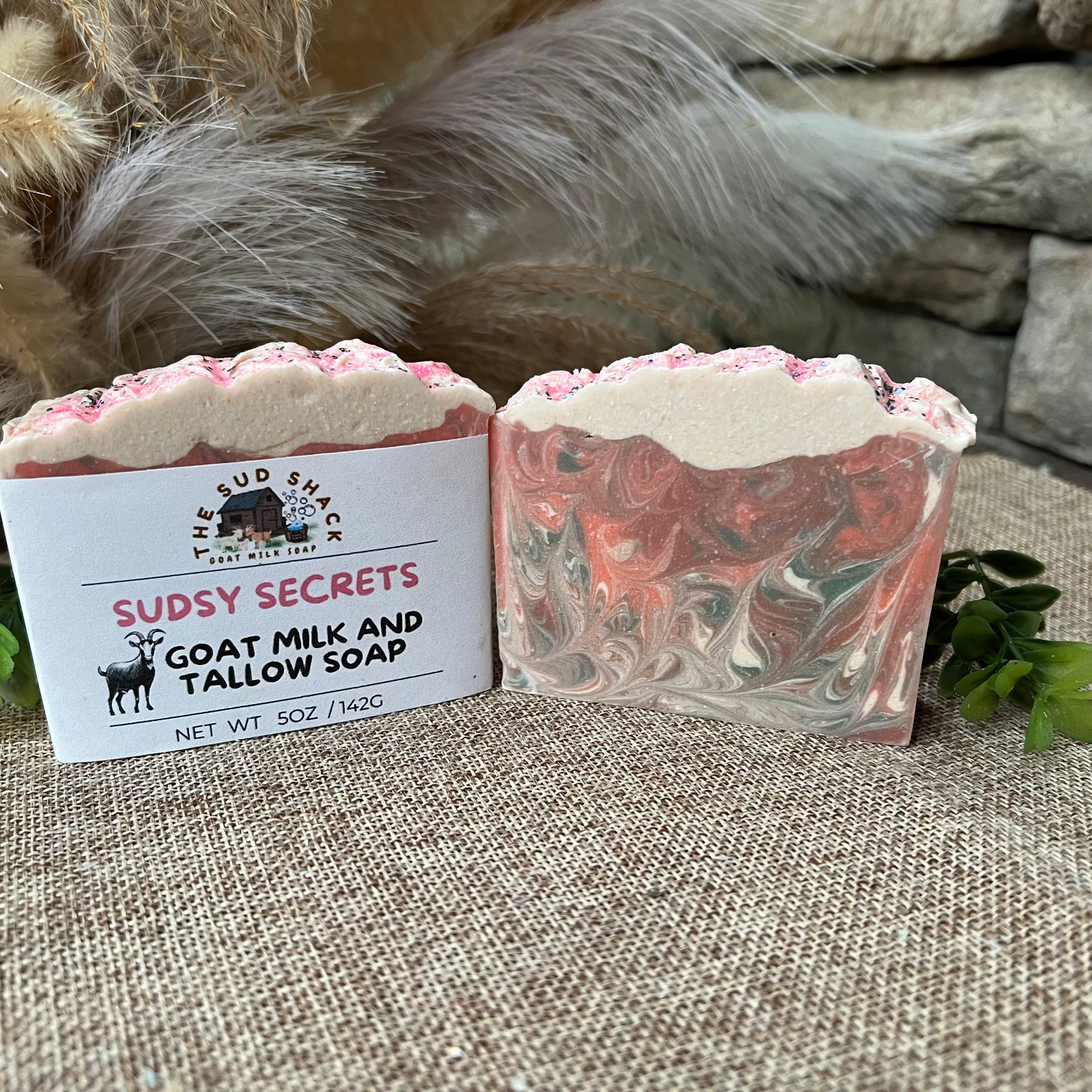 Goat milk and tallow soap with a visible label on a textured surface.