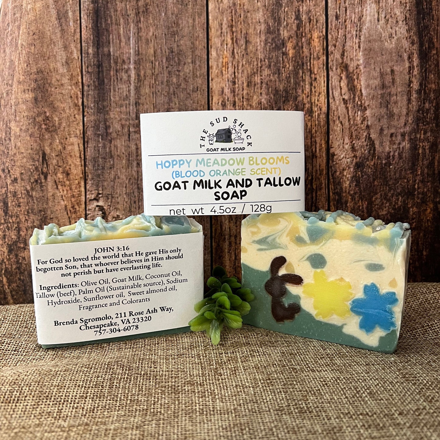 Two bars of soap with labels on a wooden surface