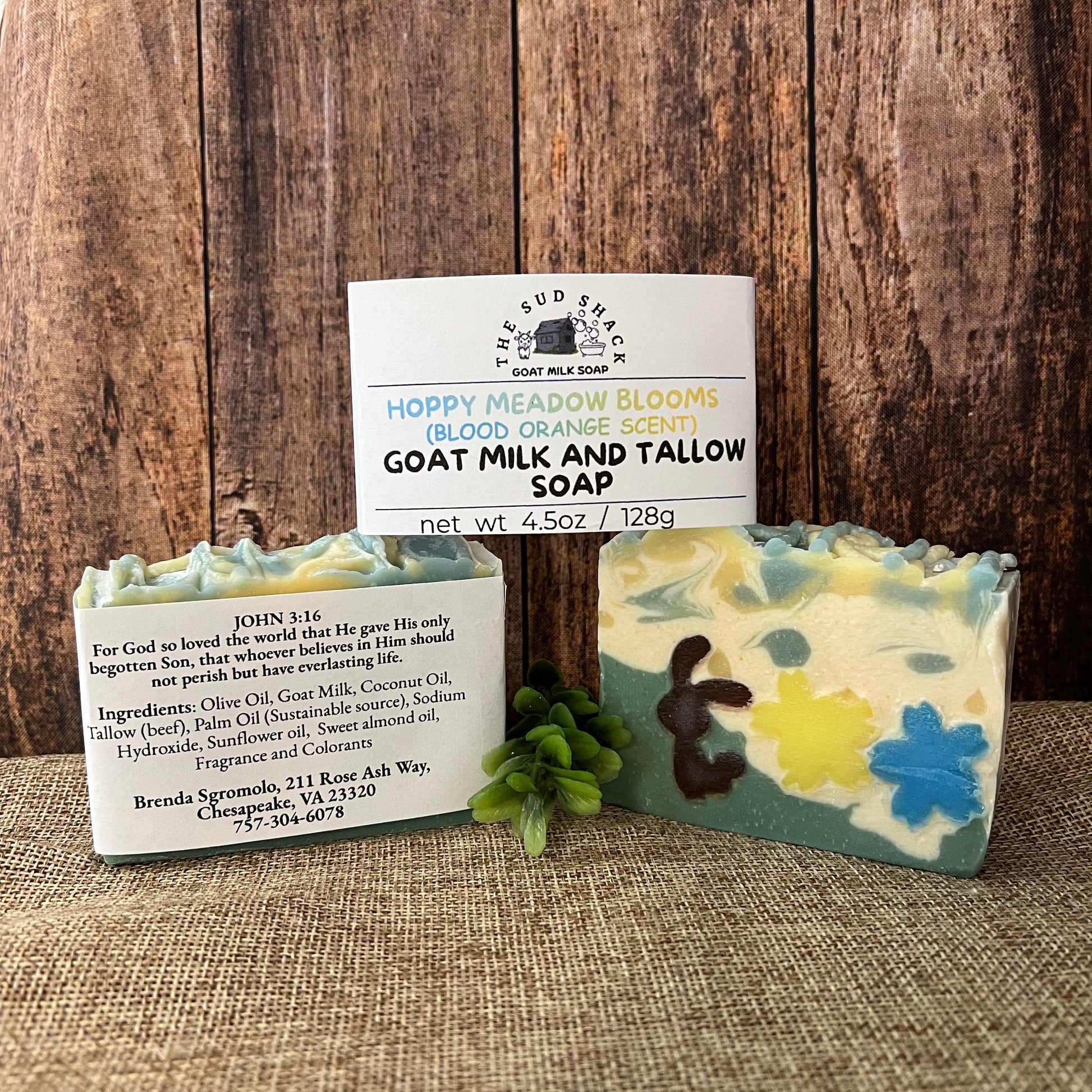 Two bars of soap with labels on a wooden surface