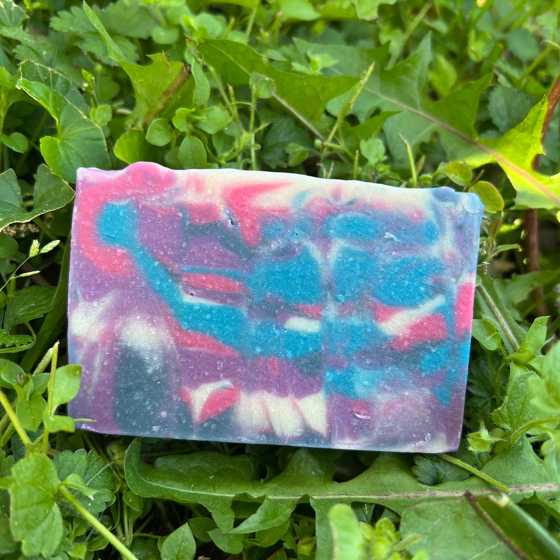 Colorful soap bar on green grass