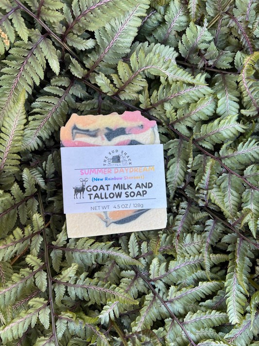Bar of soap with a label on a bed of green ferns