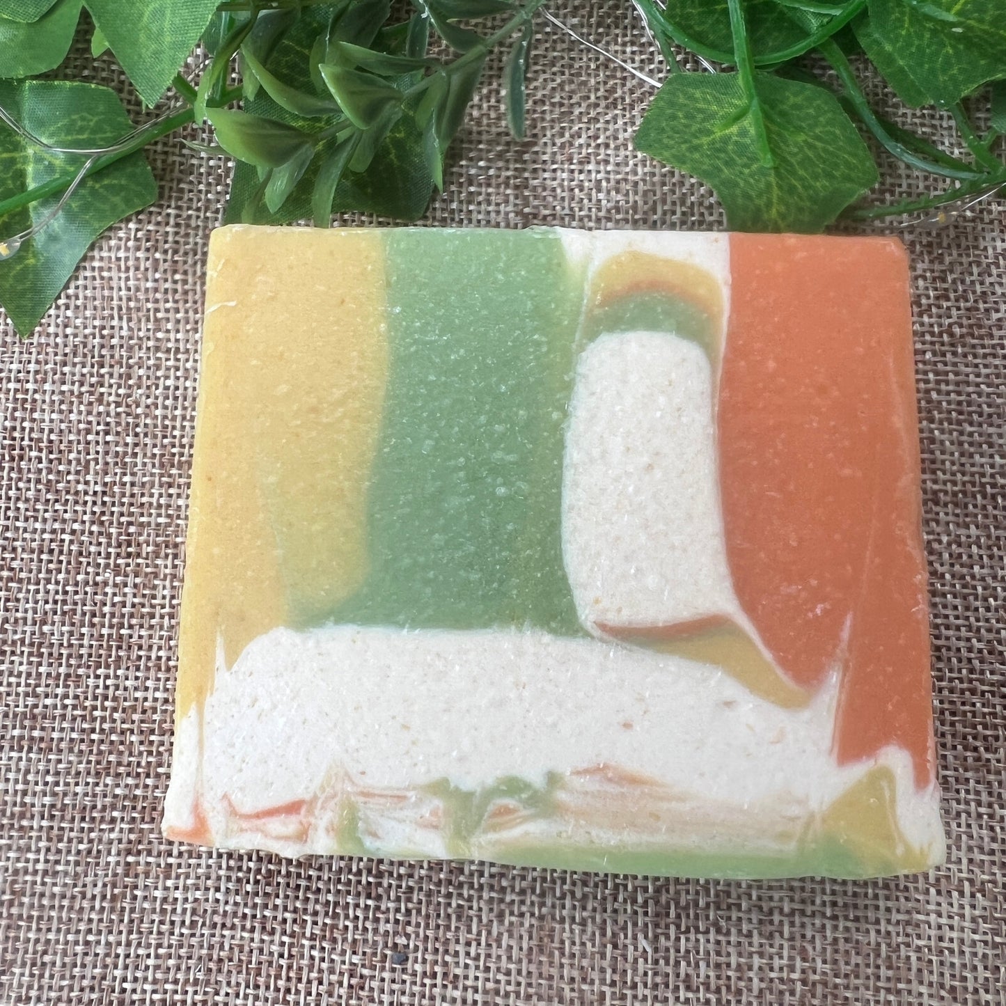 Colorful soap bar with a natural texture on a textured fabric background