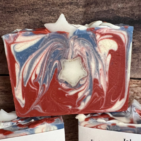 Marbled soap bars with visible brand labels on a wooden surface