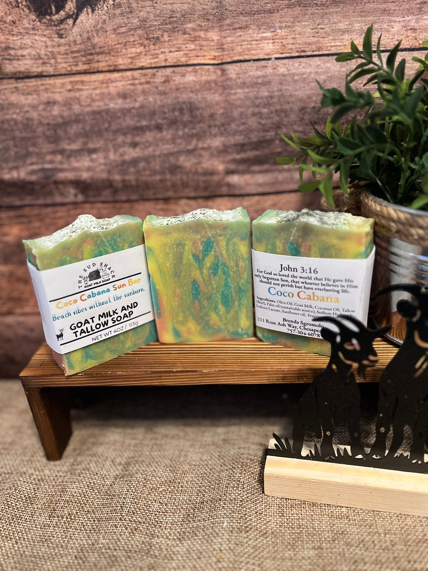 Three bars of soap on a wooden stand with a rustic background