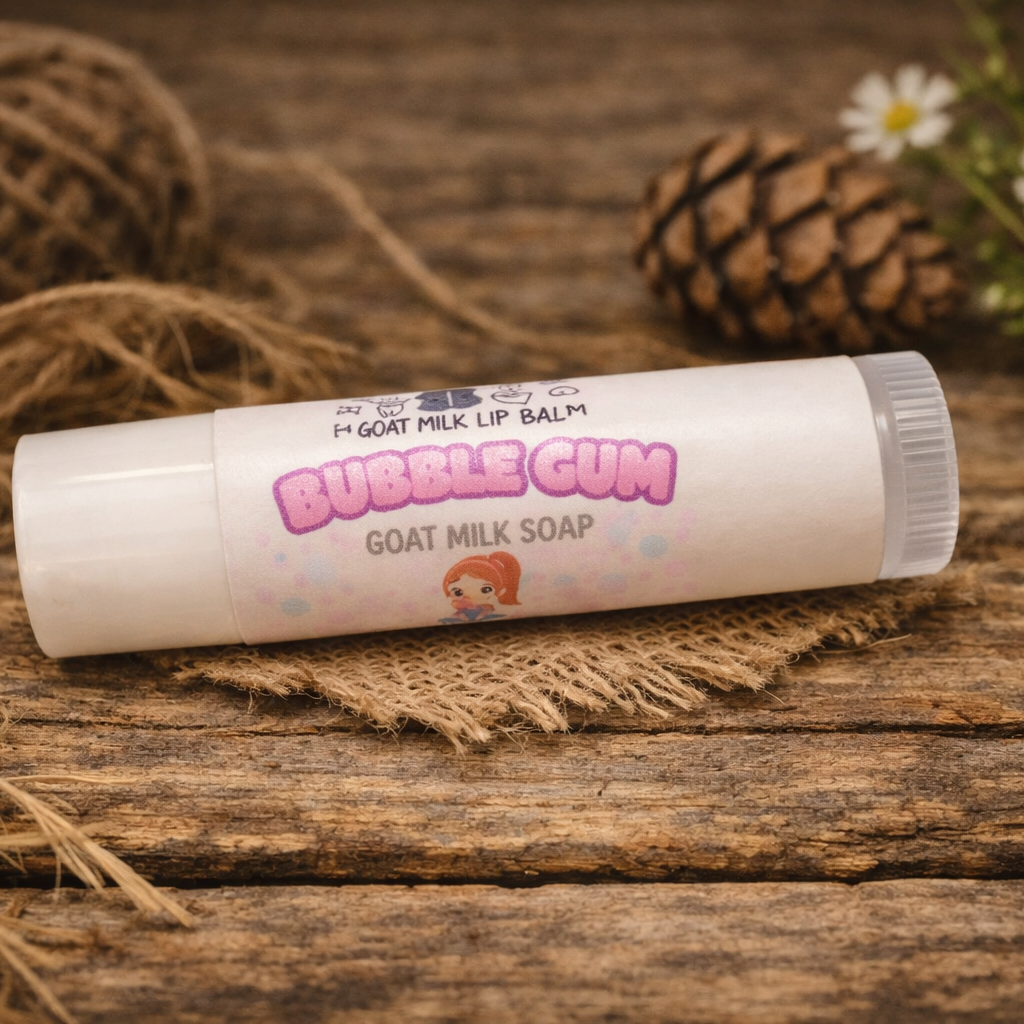 Goat milk lip balm labeled 'Bubble Gum' on a wooden surface with natural elements.