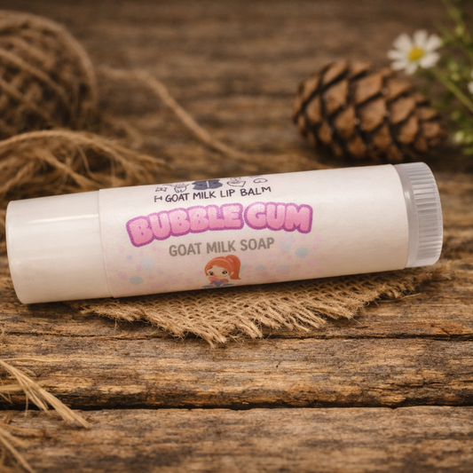 Goat milk lip balm labeled 'Bubble Gum' on a wooden surface with natural elements.